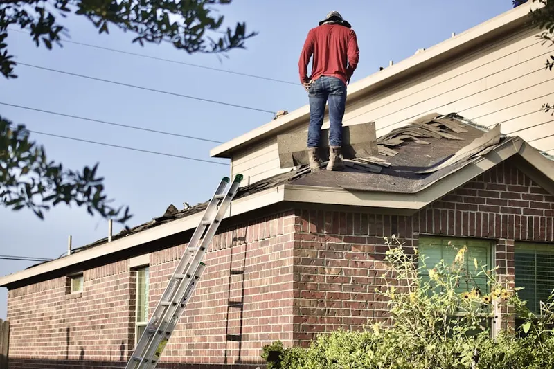 Professional roofer working on a residential roof in Damascus Terrace